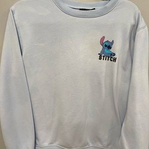 Disney woman’s size L Light Blue pullover sweatshirt featuring STITCH logo